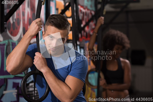 Image of Portrait of multiethnic couple  after workout at gym