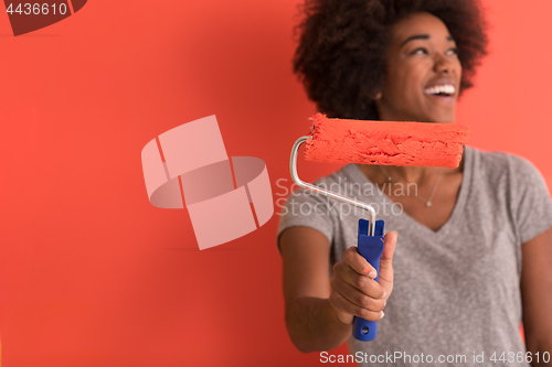 Image of black woman painting wall