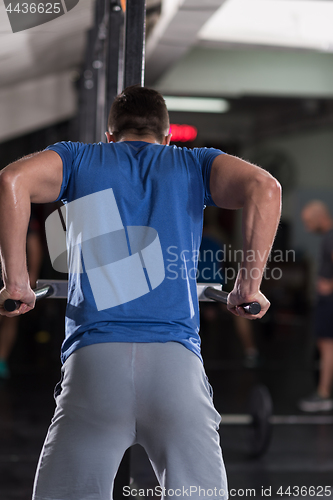 Image of man doing exercises parallel bars