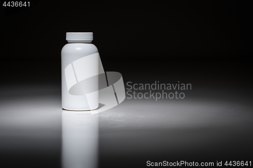 Image of Blank White Bottle Ready For Your Text Under Spot Light.