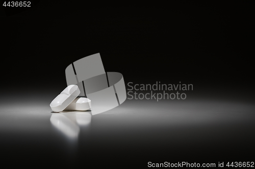 Image of Hydrocodone Prescription Pills Under Spot Light.