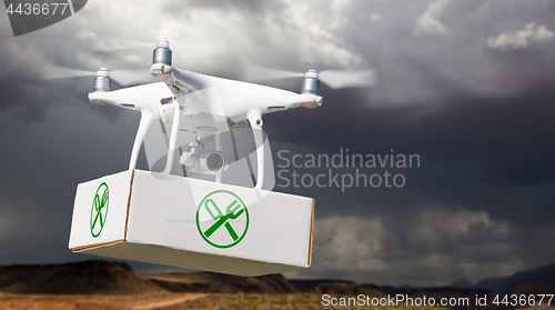 Image of Unmanned Aircraft System (UAV) Quadcopter Drone Carrying Package