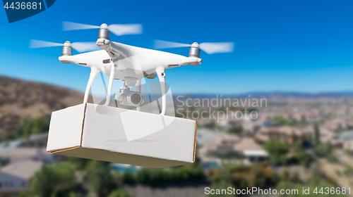 Image of Unmanned Aircraft System (UAS) Quadcopter Drone Carrying Blank P