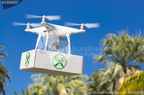 Image of Unmanned Aircraft System (UAV) Quadcopter Drone Carrying Package