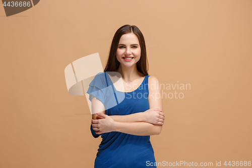 Image of The happy business woman standing and smiling against pastel background.