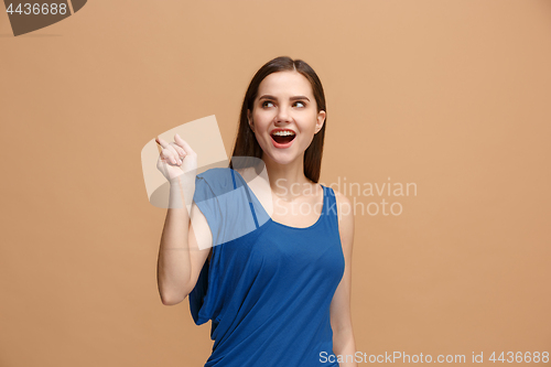 Image of The happy woman point you and want you, half length closeup portrait on pastel background.