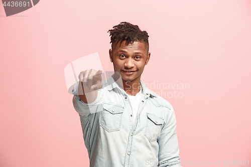 Image of The happy businessman point you and want you, half length closeup portrait on pink background.