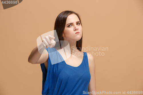 Image of The overbearing woman point you and want you, half length closeup portrait on pastel background.