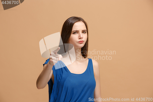 Image of The overbearing woman point you and want you, half length closeup portrait on pastel background.