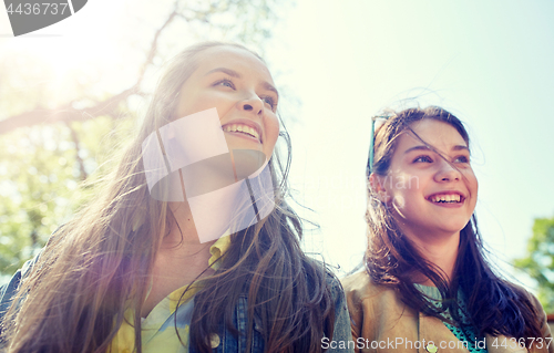 Image of happy teenage student girls or friends outdoors