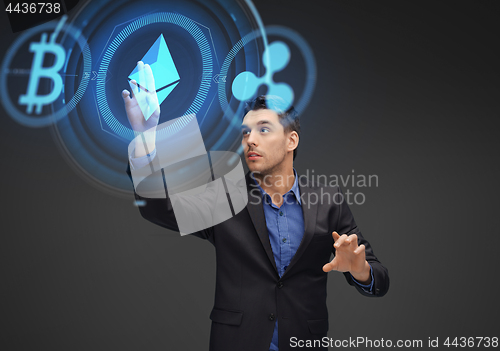 Image of businessman with cryptocurrency holograms