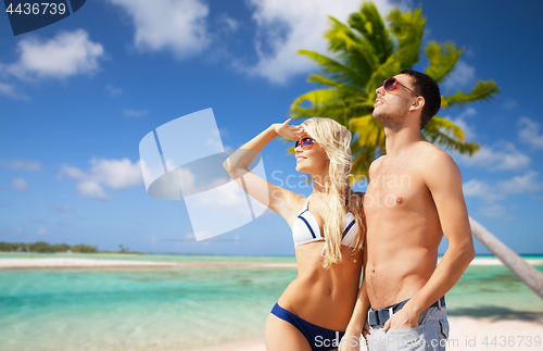 Image of happy couple over exotic tropical beach background