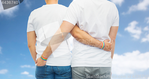 Image of male couple with gay pride rainbow wristbands