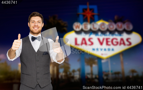 Image of happy man showing thumbs up over las vegas sign