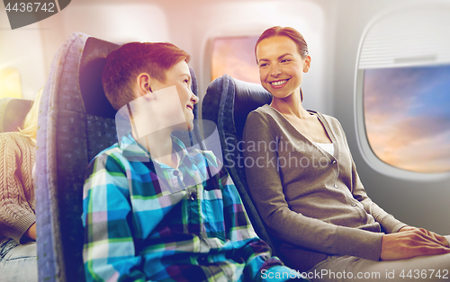 Image of happy mother and son traveling by plane