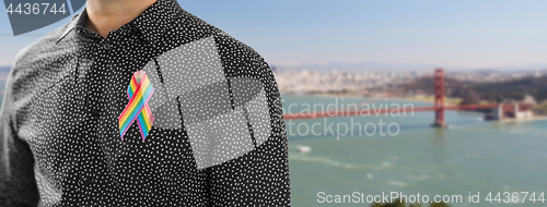 Image of man with gay pride rainbow awareness ribbon