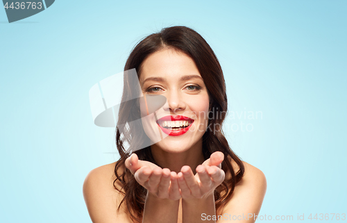 Image of beautiful smiling young woman with red lipstick