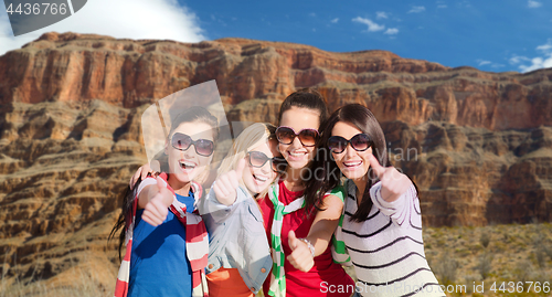 Image of teenage girls or young women showing thumbs up