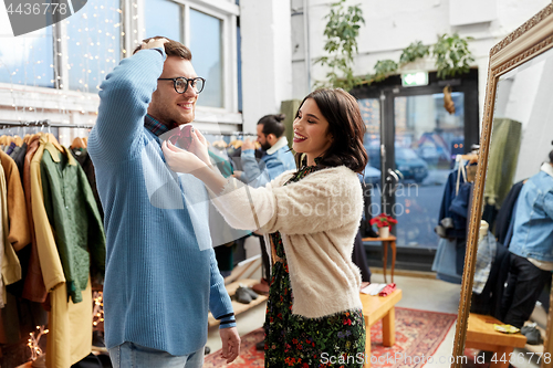 Image of couple choosing bowtie at vintage clothing store