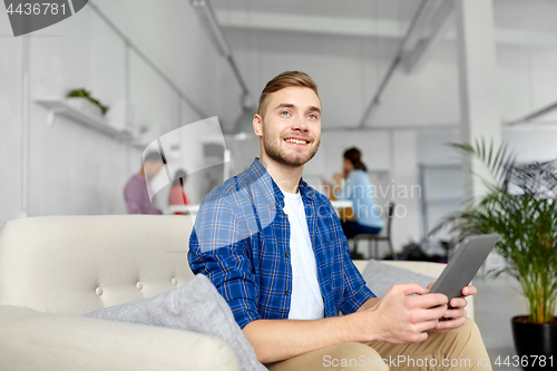 Image of man with tablet pc working at office