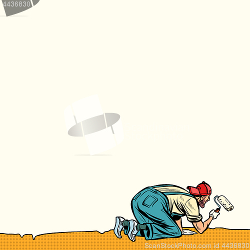 Image of worker painter paints wall at the bottom