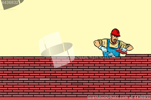 Image of The Builder lays brick masonry in the middle