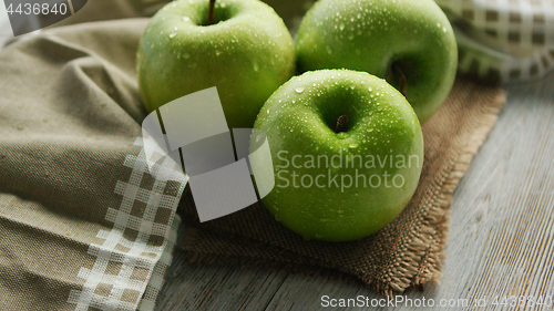 Image of Green apples in water drops
