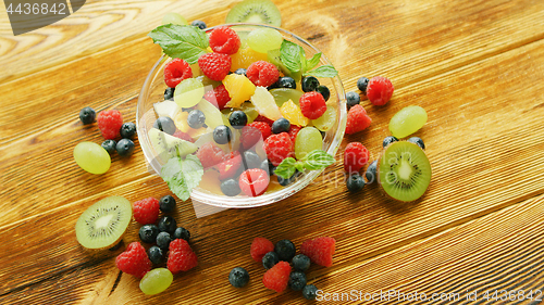 Image of Fruit salad in bowl on table 