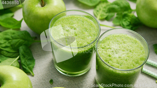 Image of Cups with green smoothie on table