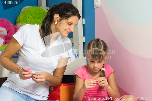 Image of Mom watches as my daughter makes crafts