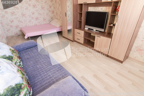 Image of The floor is covered with laminated panels in the interior of the living room