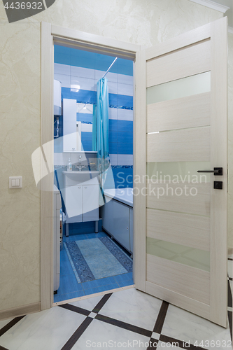 Image of The open door to the bathroom in the interior of the apartment