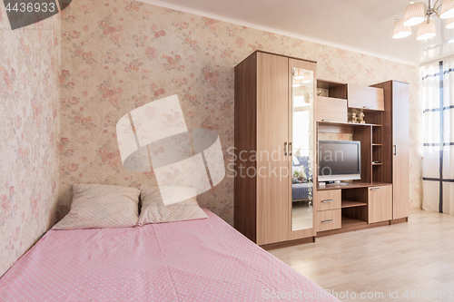 Image of Interior of the hotel room, bed, wardrobes, TV