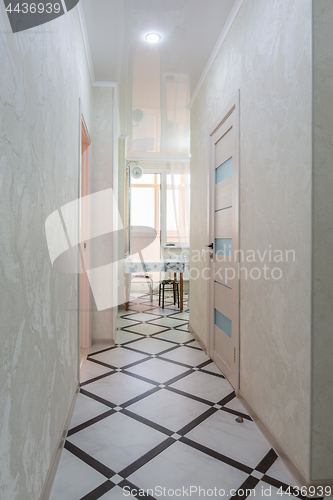 Image of A long corridor leading to the kitchen, in the apartment