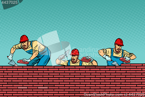 Image of construction team laying a brick wall background