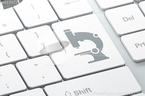 Image of Science concept: Microscope on computer keyboard background