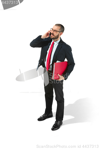 Image of Happy businessman talking on the phone with folder in hand isolated over white background in studio shooting
