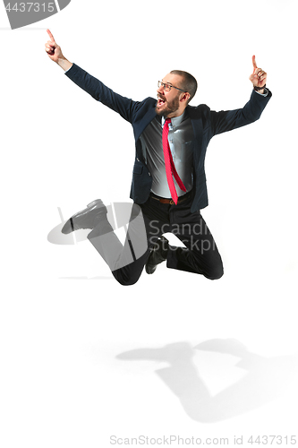 Image of Funny cheerful businessman jumping in air over white background