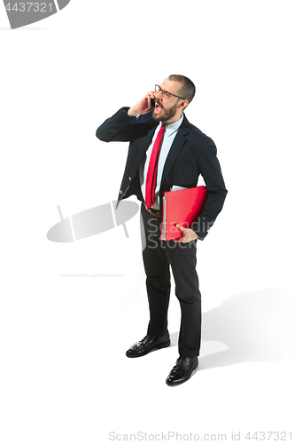 Image of Happy businessman talking on the phone with folder in hand isolated over white background in studio