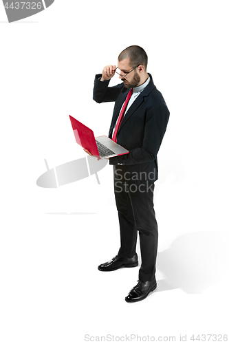 Image of Picture of handsome young bearded man standing over white studio background with laptop
