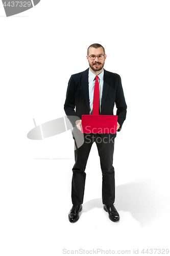 Image of Picture of handsome young bearded man standing over white studio background with laptop