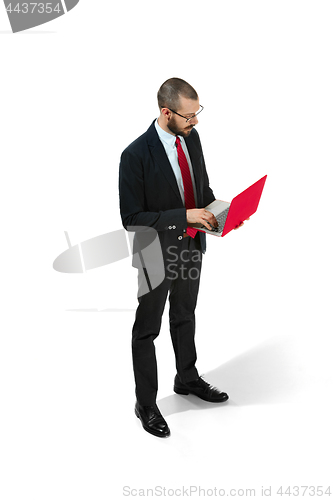 Image of Picture of handsome young bearded man standing over white studio background with laptop