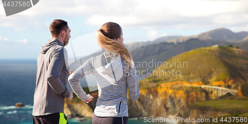 Image of happy couple running outdoors