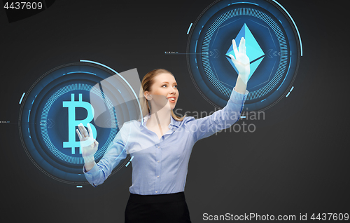 Image of businesswoman with cryptocurrency holograms