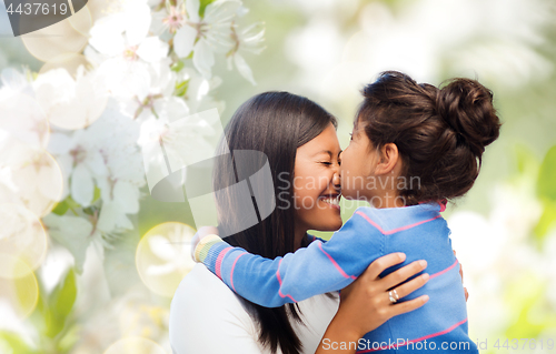 Image of happy mother and daughter hugging and kissing