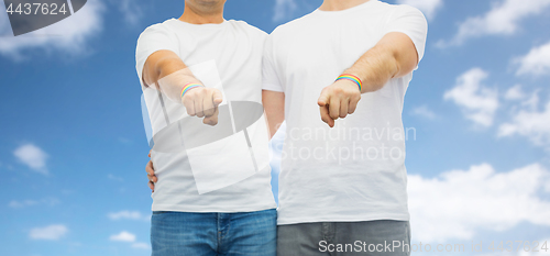 Image of couple with gay pride rainbow wristbands