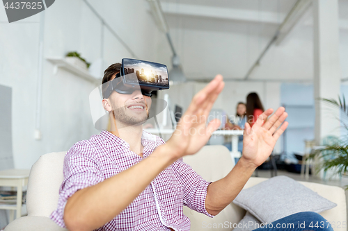 Image of happy man with virtual reality headset at office