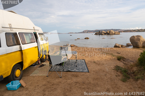 Image of Vintage minivan car on camping spot on beach on Sardinia island, Italy.