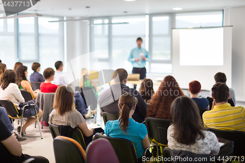 Image of Speaker giving presentation on business conference.