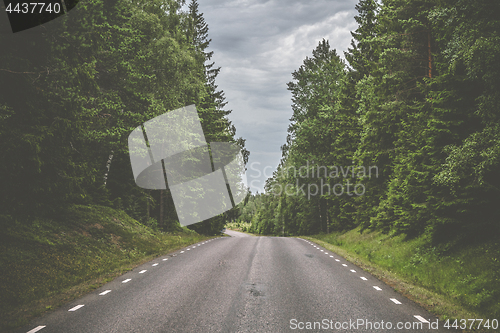 Image of Road with white stripes made of asphalt